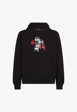 Črna kapuca, izdelana iz mešanice bombaža, z sprednjim žepom. Na prednjem delu je oblikovan motiv sedmih obrazov v rdeči, beli in črni barvi.