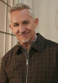 Brown plaid zip-up jacket with a collar, featuring a metallic zipper and a gray inner layer, against a neutral background.