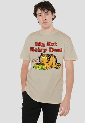 Beige cotton t-shirt featuring a cartoon cat eating from a bowl, with "Big Fat Hairy Deal" and "Garfield" text in bold red and green.