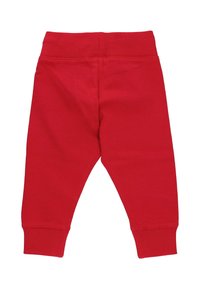 Röda bomullssweatpants med ribbad midja och cuffs. Slät textur, smalnande design. Inga synliga mönster eller hårdvara.