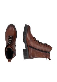 Bottines en cuir marron avec semelles noires, fermeture éclair latérale et laçage à l'avant, vues de dessus et de côté sur fond blanc.