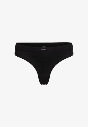 Juodas thong tipo apatinis trikotažas iš minkštos medžiagos, su lygiu juosmeniu, minimalistinio dizaino ir maža etikete, ant kurios užrašyta "KARL LAGERFELD".
