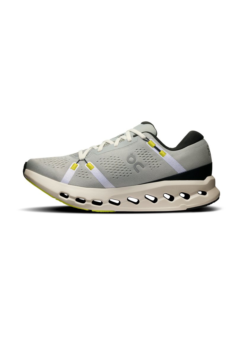 Grey athletic shoe with a breathable mesh upper, white and yellow accents, rounded sole with cutouts, and a textured black heel.