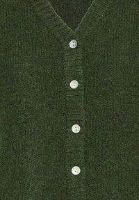 Cardigan en maille vert foncé avec un col en V et une rangée de quatre petits boutons ronds blancs sur le devant.