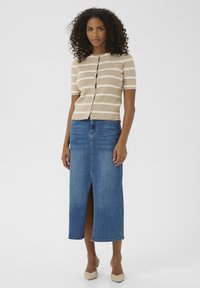Beige and white striped short-sleeve cardigan with buttons, paired with a denim pencil skirt featuring a front slit.
