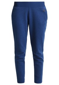 Námořnické modré slim-fit tepláky s elastickým pasem, postranními kapsami a logem Adidas na horní levé stehně.