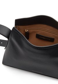 Black textured leather handbag with an open top, a brown interior, a zip pocket, and a small label inside. Smooth, structured design.