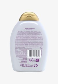 Gjennomsiktig flaske med rund topp og gullaccent. Inneholder lilla tekst på baksiden som beskriver produktnavn og bruksanvisning. 385 ml.