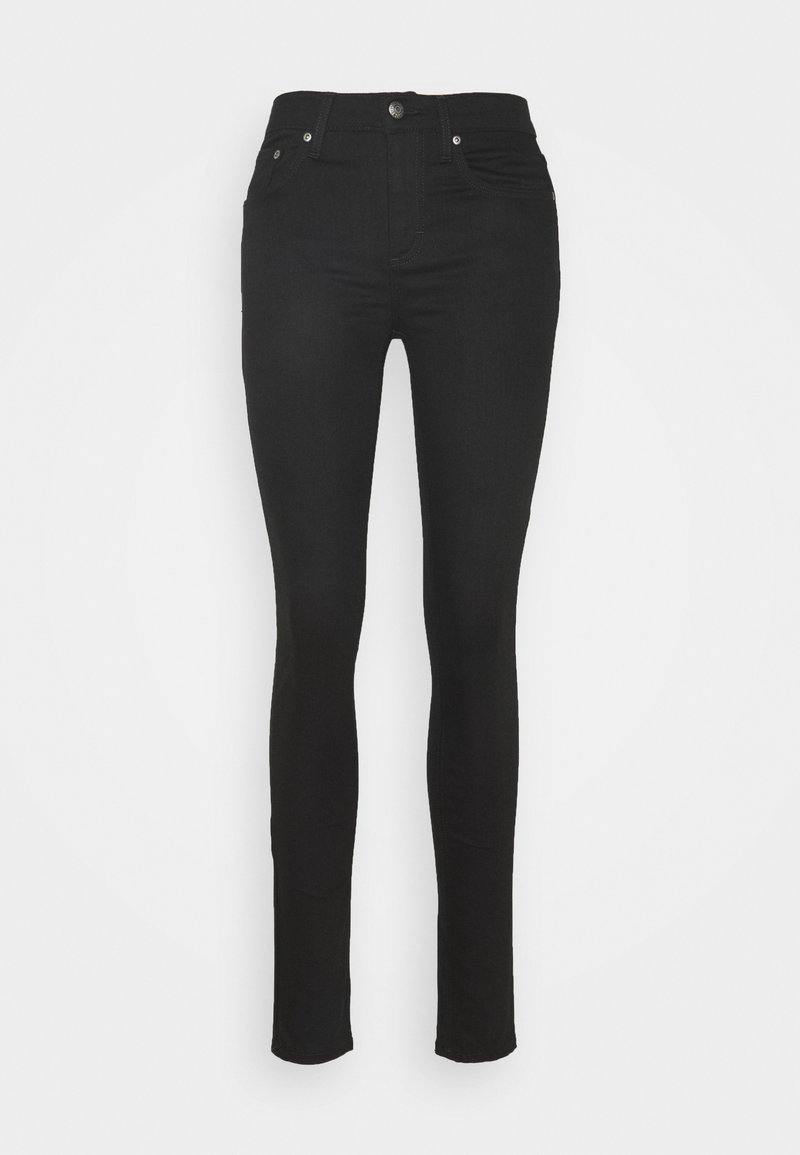 Jeans skinny negros hechos de denim elástico, con diseño de cinco bolsillos, cierre frontal con botón y detalles de costura sutiles en los lados.