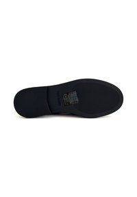 Suola di scarpe nera con una superficie testurizzata, forma arrotondata e logo del marchio. Presenta scanalature evidenti per trazione e stabilità.