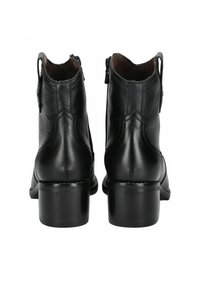 Bottines en cuir noir avec un bout rond et un talon épais. Elles possèdent des fermetures éclair latérales doubles et des coutures décoratives à l'arrière.