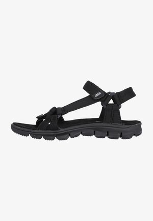 Black sandal with adjustable straps, rubber sole, textured footbed, and padded ankle support. Lightweight design suitable for casual wear.