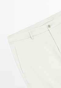 Beige cotton trousers featuring a flat front, side pockets, and a single button closure. The fabric has a smooth texture with a slight sheen.