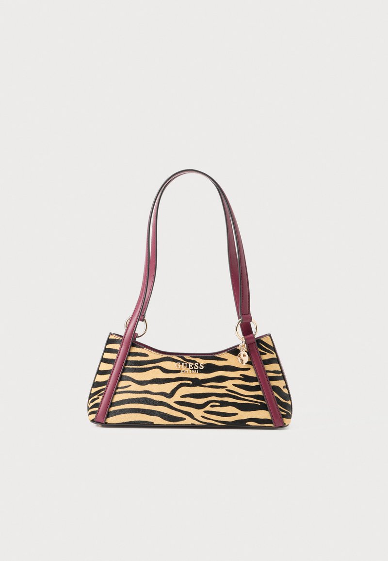 Small handbag with tiger print pattern, maroon leather straps, gold-tone Guess logo, and a charm hanging from the strap ring.