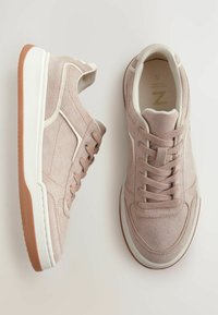 Baskets en suédine rose clair avec une semelle en caoutchouc blanc, design à lacets et accents latéraux contrastants. Texture douce avec un col rembourré.