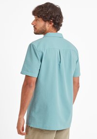 Short-sleeve button-up shirt in light blue, textured fabric. Features a classic collar, back pleat, and curved hem. Suitable for casual wear.