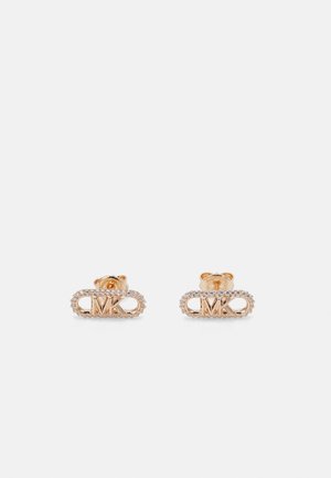 Gold-tone stud earrings featuring an oval design with a sparkling border and "MK" logo in the center, embellished with small stones.
