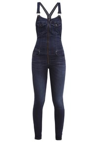 Salopette cintrée en denim bleu foncé avec fermeture éclair à l'avant, poches poitrine boutonnées, poches latérales et bretelles réglables croisées dans le dos.