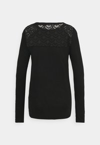 Svart långärmad topp med spetsmönstrad yoke över den övre delen av ryggen och en enfärgad kropp och ärmar.