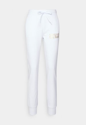 Weiße Trainingshose aus weichem Material mit einem Kordelzugbund und gerippten Bündchen. „Versace Jeans Couture“-Logo in Gold an der Seite gedruckt.