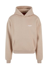 Beige hettegenser laget av mykt stoff. Har en frontlomme, ribbede mansjetter, og er lett cropped. Brodert tekst på brystet.