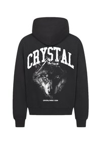 Felpa nera con cappuccio caratterizzata da un grande graficone bianco di un volto di lupo e testo "CRYSTAL Paris" sul retro. Tessuto misto cotone, vestibilità rilassata.