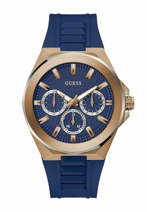 Orologio con cinturino in gomma blu navy e dettagli dorati, quadrante blu testurizzato, tre sottodial e marcatori delle ore in un audace design della cassa esagonale.