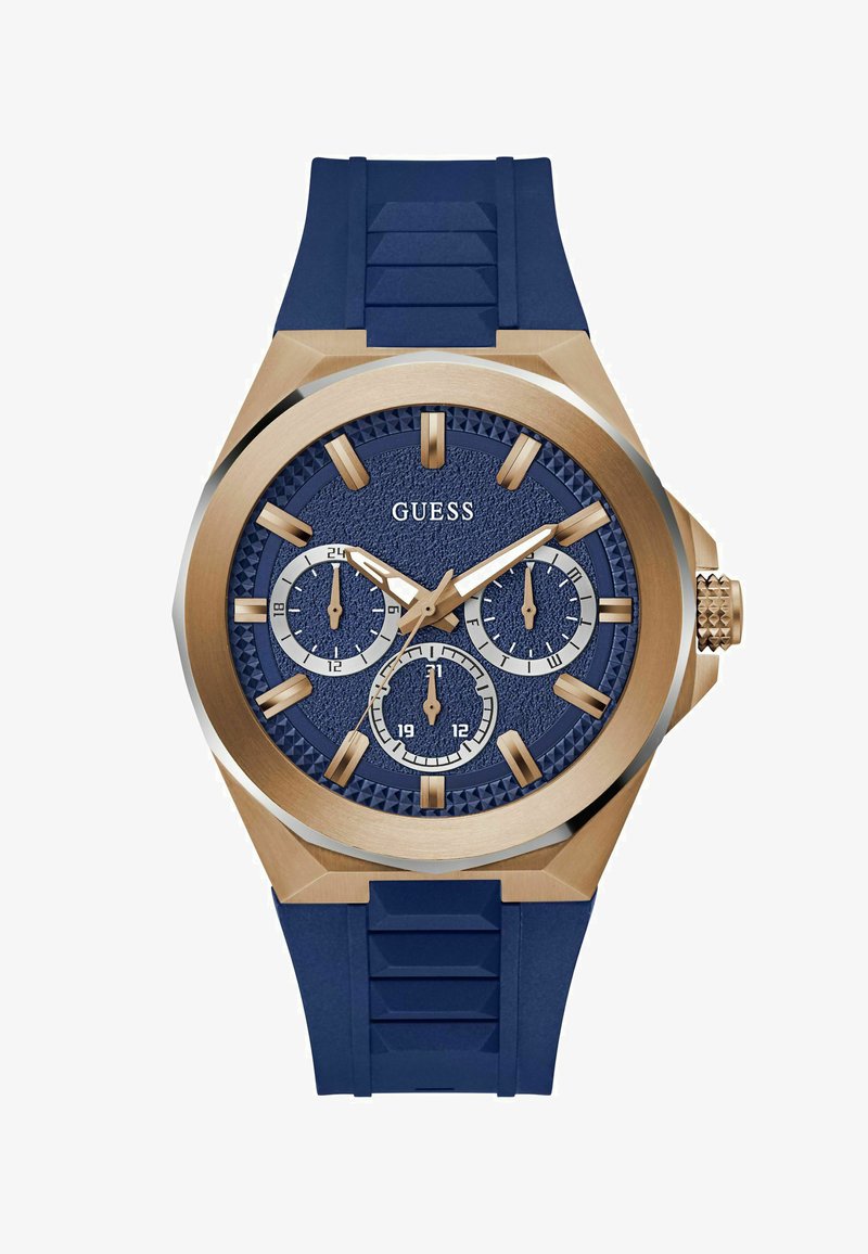 Orologio con cinturino in gomma blu navy e dettagli dorati, quadrante blu testurizzato, tre sottodial e marcatori delle ore in un audace design della cassa esagonale.
