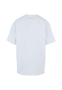 T-shirt en coton blanc, manches courtes, col rond, coupe décontractée, texture lisse, sans graphiques ni motifs, couleur unie. Vue de dos présentée.