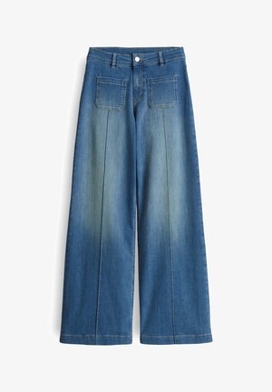 Wide-leg, blue denim pants with a faded wash, two back pockets, and a smooth finish. Features a classic button and zipper closure.