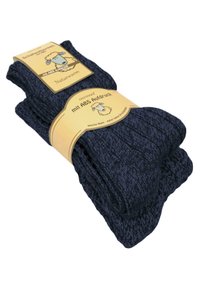 Dunkelblaue, gestrickte Socken mit ribbeliger Textur und gelber Verpackung, die ein Schaf-Logo und Informationen über Grip und Weichheit zeigen.