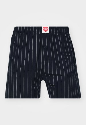 Marineblauwe boxershorts met dunne witte verticale strepen, elastische tailleband, enkele knoopsluiting en merklabel met een hartlogo.