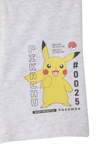 Gray fabric featuring Pikachu illustration, yellow with black accents. Text includes "PIKACHU" and details about height/weight and a Pokéball.