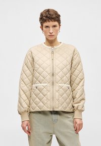 Μπεζ επικαλυμμένο μ�πουφάν με ριμπ μανσέτες και γιακά, διαθέτοντας μπροστινό φερμουάρ και δύο πλαϊνές τσέπες με λευκές λεπτομέρειες. Ελαφρώς επενδεδυμένο σχέδιο.