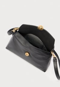 Sort lædertaske med guldfarvet knappelukning og indvendig lomme. Glat tekstur, minimalistisk design og justerbar rem.