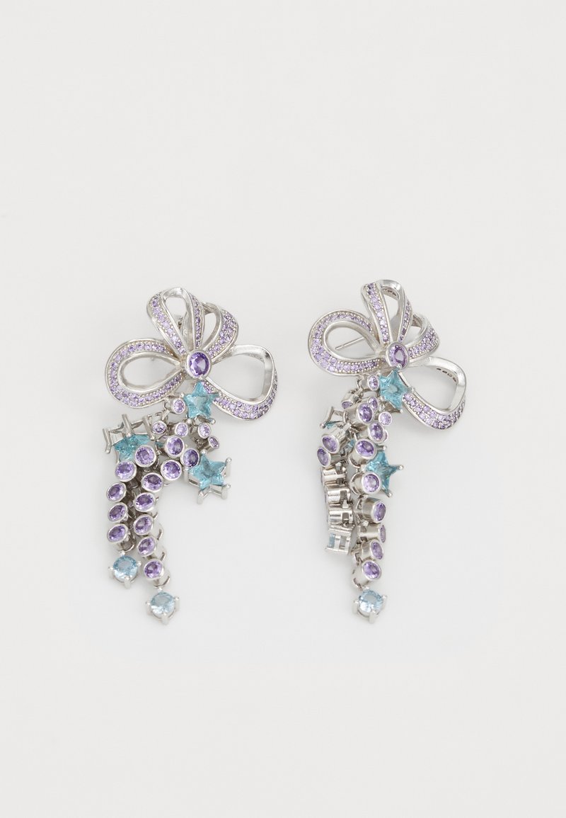 Silver earrings shaped like bows with purple and blue stones, featuring intricate designs and varying shapes, including round and star.