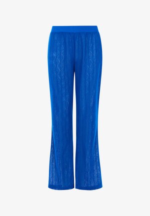 Niebieskie spodnie w wzory z szerokimi nogawkami. Wykonane z lekkiego, teksturowanego materiału z diamentowym wzorem i elastycznym pasem.