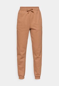 Brown cotton joggers with an elastic waistband, drawstring, and tapered cuffs. Features a smooth texture and relaxed fit.