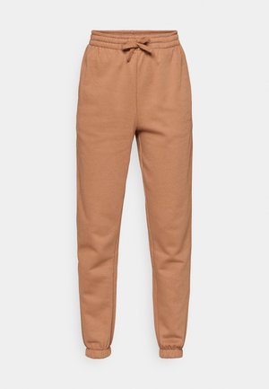 Pruunid puuvillased joggers elastse vöökoha, nööriga ja kitsenevate varrukatega. Omab siledat tekstuuri ja lõdvestatud istumist.