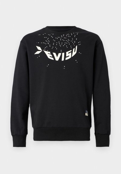 Sweat-shirt noir en coton avec un col rond. Il présente un grand design graphique blanc et des accents à pois dispersés sur la poitrine.