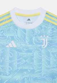 Maglia da calcio blu chiaro con un motivo ondulato e strutturato. Collo a girocollo bianco e tre strisce gialle sulle spalle. Presenta i loghi di Adidas e Juventus.