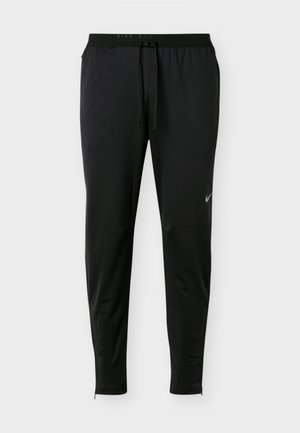 Crne Nike trkaće hlače suženog kroja s vezicom u struku, bočnim džepovima i malim reflektirajućim Nike logom na lijevom bedro.