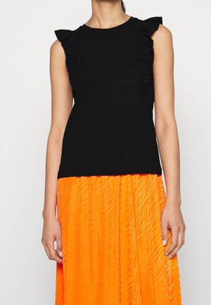 Black sleeveless top made from soft fabric features ruffled accents along the shoulders. Paired with a bright orange pleated skirt.