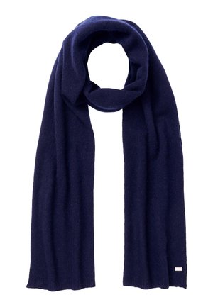 Dark navy blue knitted wool scarf folded in a loose loop with ends hanging straight, small rectangular label at one end.