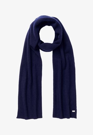 Écharpe en laine tricotée bleu marine foncé, pliée en boucle lâche avec les extrémités pendantes, petite étiquette rectangulaire à une extrémité.