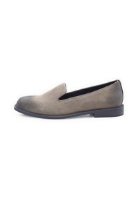 Slip-on shoe in light gray suede with a textured finish, featuring a slight heel and a rounded toe. The design includes a cutout detail at the vamp.
