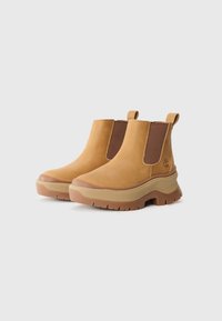 Brown leather ankle boots with elastic side panels, textured rubber soles, and pull tabs. Features a padded collar and contrasting midsole.