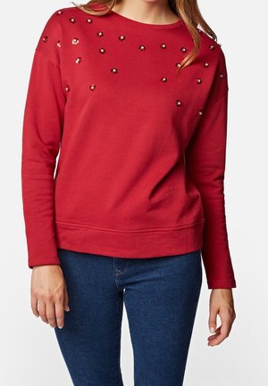 Rotes Sweatshirt mit rundem Halsausschnitt und langen Ärmeln, mit dekorativen, mit Pailletten besetzten Blumenakzenten auf der Vorderseite. Glattes Baumwollmischgewebe.