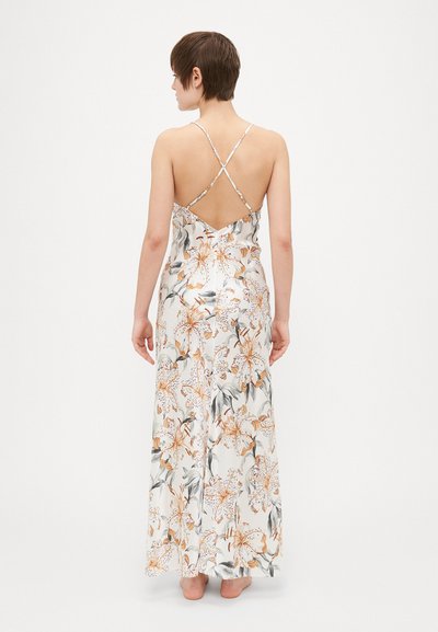 Maxi dress with floral print, featuring a white base and orange flowers, adjustable thin straps, and a low V-back design. Flowing fabric.