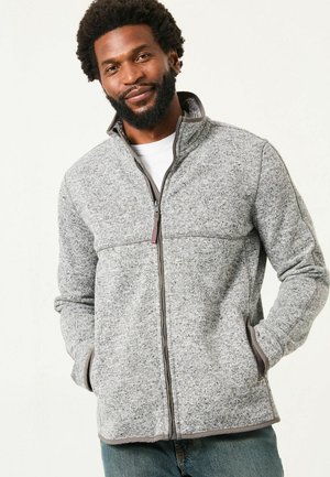 Gray fleece jacket with zip closure, high collar, and side pockets. Features contrasting dark gray trim and textured knit pattern.